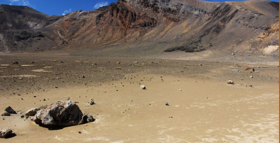 Crater basin of volcanic-derived sands and weathered clasts with sparse lichen, Tongariro Crossing
