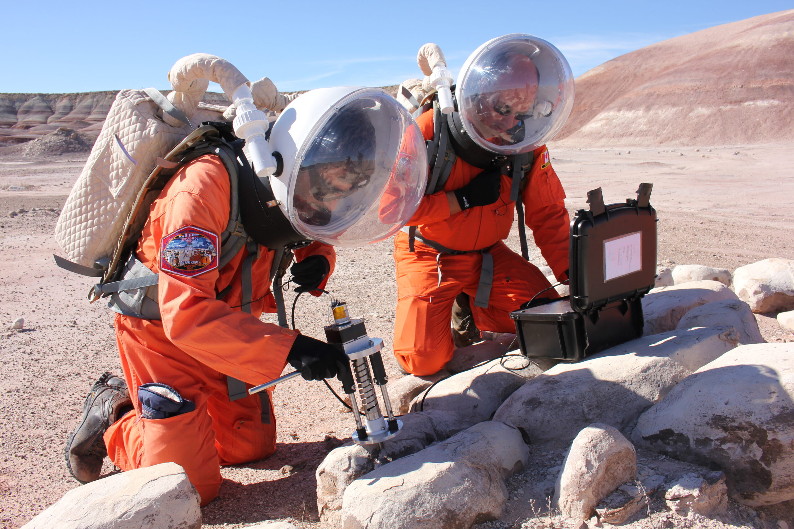 Dr Jonathan Clarke, at left in the orange suit, during a Mars analogue simulation
